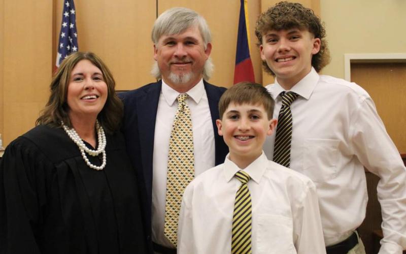 Photo by Carissa Daniels From right, Senior Resident Superior Court Judge for North Carolina District 43A Tessa Sellers, her husband, Joe Jack Sellers and sons, Rhett and Jackson celebrate Tessa accepting her position.