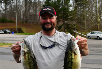 Dean Tucker shows off the 4.09 pound spotted bass that earned him the big fish.
