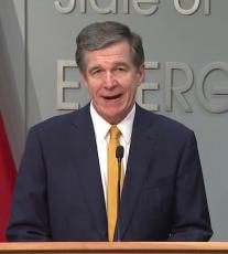 Gov. Roy Cooper explains the steps in the Phase I modification to his Stay At Home Executive Order.