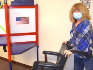 (Travis Dockery • Clay County Progress) Board of Elections Deputy Director, Patty Swanson, prepares a handicap accessible voting booth in preparation for early voting which begins Thursday, Oct. 15. Voters can take advantage of early voting on the square at 54 Church Street.