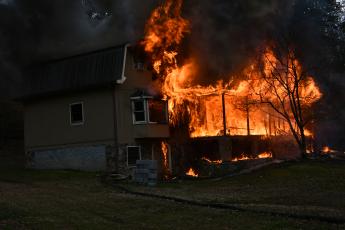 (Photo by Joe Davenport) Upon arrival to the home on Hot House Road, firefighters discover the house is fully involved and not safe to enter. 