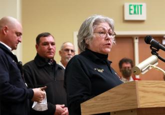 (Jared Putnam • Clay County Progress) Fire Chief Paulette Tonielli, of the Brasstown Volunteer Fire Department, speaks during the Clay County Commission m. From left, fire chiefs Brian Anderson, Henry Angelopulos and Pete Trocchia look on.