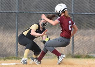 (Travis Dockery • Clay County Progress) Breanna Abrams tries to apply the tag to a runner on third.  The runner was called safe.