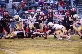 (Kelli Graves • Clay County Progress) Kyle Lunsford goes for and recovers a loose ball after a Wildcat fumble.
