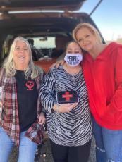 (Regina Cothren • Photo submitted) Stephanie Almeida, of Smoky Mountain Harm Reduction, brought Narcan kits to give free in Clay County on Saturday, March 20. She will be back from 1-2 p.m., Saturday, March 27 at Oak Forest UMC, 990 Oak Forest Road in Hayesville. Almeida (center) stands with People of Clay CARE board member Debbi Tucker, left, and Stacie Ledford from Rock Bottom Recovery and Support, right.