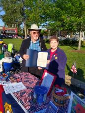 Mayor Baughn signs the Poppy Proclamation declaring Friday, May 28 National Poppy Day. He signed the proclamation during the Town Yard Sale event on Saturday, May 15 at the Auxiliary Poppy Table display.