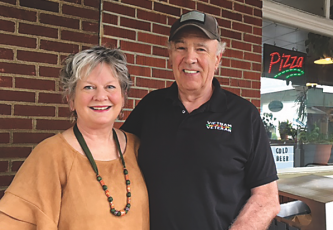 (Marcia Barnes • Clay County Progress) Marsha Lee Baker and Tom Baker stand outside the Clay County Progress building on their recent visit to Hayesville.