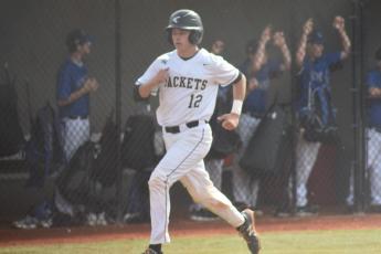 Avery Leatherwood trots into home to score a run for the Jackets.