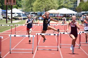 (Kevin Hensley • Graham Star) Emma Shook hurdles her way to a spot in the state championship event.