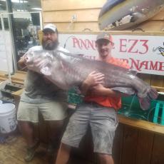 Rocky Baker needs help holding up his new state record blue catfish.