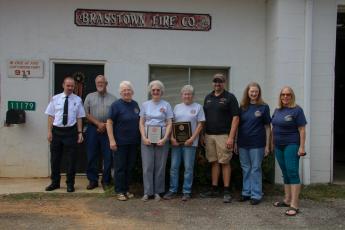 From left, CCFR Asst. Chief Chris Denton; Clay County Commissioner Clay Logan; Brasstown Fire Dept. Officers and Board Members Joyce Portik, Judy Grove, Paulette Tonielli, Tim Noland, Charlotte Bristow and Linda Allen.