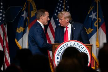  Congressman Ted Budd with Donald Trump at the 2021 NCGOP Convention where Trump endorsed Budd for U.S. Senate. (Photo from Carolina Journal.)