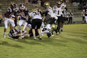 Hannah Styles Herrin • Smoky Mountain Times Freshman Michael Mauney lunges forward for positive yardage against Swain.