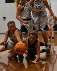 (Kevin Hensley • The Graham Star) Hayesville’s Ava Shook tries to block a Lady Knight from getting the ball while preventing the ball from going out of bounds. 