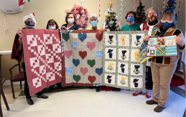 From left, quilter Marilyn Thompson, Clay County Care Center staffers Rosemary Harvey, Community Life Coordinator, Melissa Ditmore, nurse, Gail Dockery, CNA, and quilters Jan Kitchen, Robin Jones and Shirley Deasy.