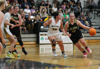 Breanne Cothren drives the ball down court looking for a Lady Jacket basket.
