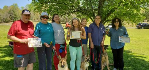 Celebrating the AKC S.T.A.R. puppy class graduation are, from left, Jim and Paige Welling and "Roxy;" trainer, Mitzi Shephard, Michelle Poole and "Ash;" trainer, Linda Vanderlaan and Andy and Debbie Accetturo and "Gertie.”