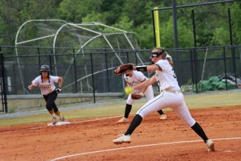 Addie Bunch throws a great pitch as a Lady Bulldog attempts a steal to home.