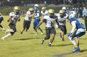 Gary Corsair • Clay County Progress Hayesville's Taylor McClure, No. 20, follows blockers Asher Brown, No. 1, and Seth McCaslin, No. 50, after Lane O'Dell, No. 60 and Zek Furby, No. 71, opened a huge hole. McClure gained 118 yards with bullish running as the offensive line turned in a superb performance.