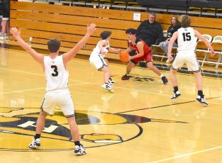 Gary Corsair • Clay County Progress Yellow Jackets E.J. Abrams, No. 3, Cooper Matheson, No. 2 and Kyle Shaheen, No. 15, trap Andrews near half court during the frantic final minute of Saturday's JV game. Hayesville fought valiantly and nearly engineered a comeback but fell to the Wildcats.