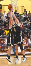Hayesville's Luke Lee, No. 4, stretches to collect one of his 13 rebounds against Cherokee as teammate Slade Crouch also pursues the board.