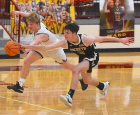 Gary Corsair• Clay County Progress Hayesville's Slade Crouch beats a Swain player to the ball in a race for possession near half court in the second half of the varsity Yellow Jackets victory.