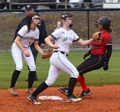 Gary Corsair • Clay County Progress Jasmine Brooks, No. 3, and Junior Raylyn Taylor, No. 11, await the throw from the plate during a Pisgah steal of second. 