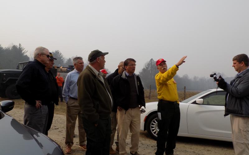 (Progress photo by Lorrie Ross)   Then NC Governor Pat McCrory made a Sunday morning trip to Clay County to see the fires in person. The forestry department’s incident command personnel point out Shooting Creek firelines from a safe distance. 