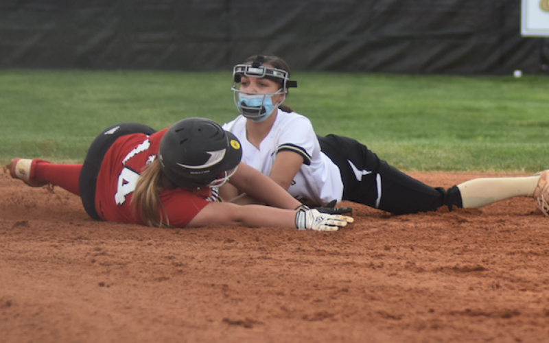 (Travis Dockery • Clay County Progress) Jayden Moore applies the tag to stop a Lady Wildcat from reaching second base.
