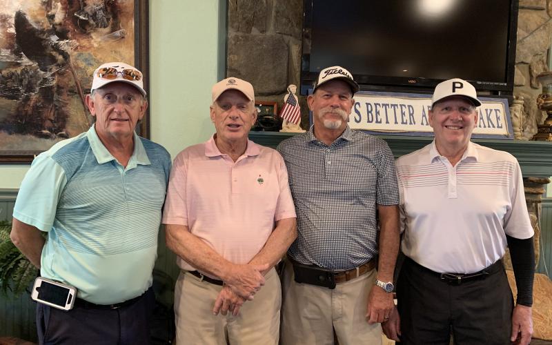 Gross winners, from left, Benny Parten, Woody Chastain, Jerry Brinke and Jimmy O’Brien stand shoulder-to-shoulder as the top team.