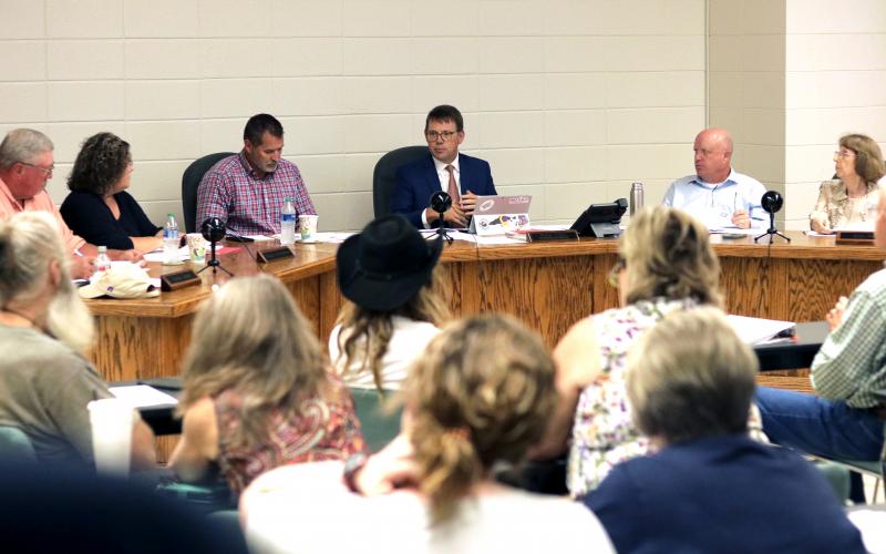 (Jared Putnam • Clay County Progress) Clay County School Superintendent Dale Cole, center, discusses social media standards while, from left, Board of Education members Danny Jones, Kelly Crawford, Chairperson Jason Shook, Vice-Chairperson Robert Caldwell and Reba Beck listen during the July meeting on Monday.