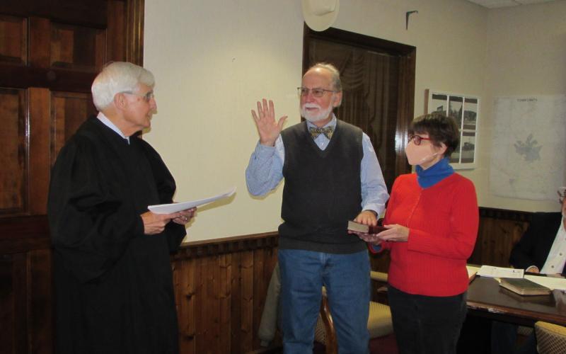 (Progress photo • Lorraine Bennett)  Judge Willis Whichard, left, retired from the N.C. Supreme Court, administers the oath   of office to incoming Hayesville Mayor Joe Slaton as wife Wendy holds the Bible.