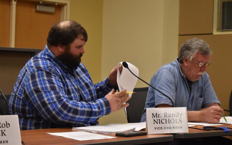 Commission Chair Randy Nichols and commissioner Dwight Penland review the moratorium that prevents crypto mining in the county for several months.