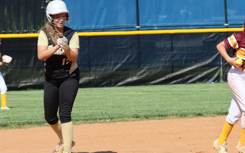 Deby Jo Ferguson • Clay County Progress Bryleigh Kreiger lets her safe landing on second base shine and scores one run.