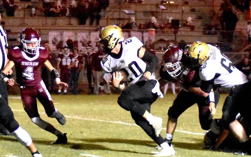 Gary Corsair • Clay County Progress Taylor "Hit-and-Run" McClure, No. 20, high-steps his way through Red Devils as he adds to his rushing total of 101 yards. 