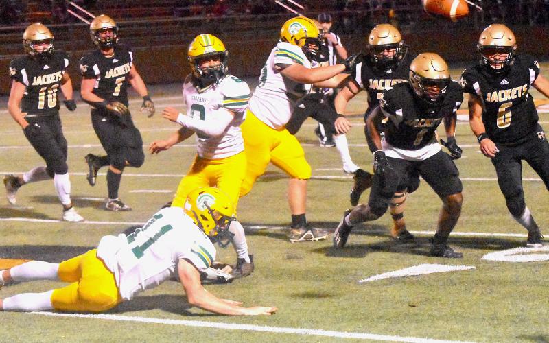 Yellow Jackets Asher Brown, No. 1, Logan Caldwell, No. 6, and Dawson DeVane read an Alleghany pitchout with 20/20 vision during Hayesville’s 37-22 playoff victory Friday. Jackets Avery Leatherwood, No. 10, and Kyle Lunsford, No. 7, pursue from the weak side.