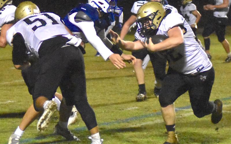Gary Corsair • Clay County Progress Dawson DeVane, No. 32, explodes through the line thanks to Jeremy Graves, No. 51, as Hayesville moves into Christ The King territory during the second half of the Yellow Jackets second-round playoff victory.
