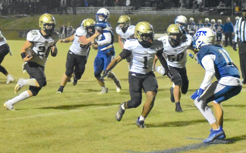 Gary Corsair • Clay County Progress Hayesville's Taylor McClure, No. 20, follows blockers Asher Brown, No. 1, and Seth McCaslin, No. 50, after Lane O'Dell, No. 60 and Zek Furby, No. 71, opened a huge hole. McClure gained 118 yards with bullish running as the offensive line turned in a superb performance.