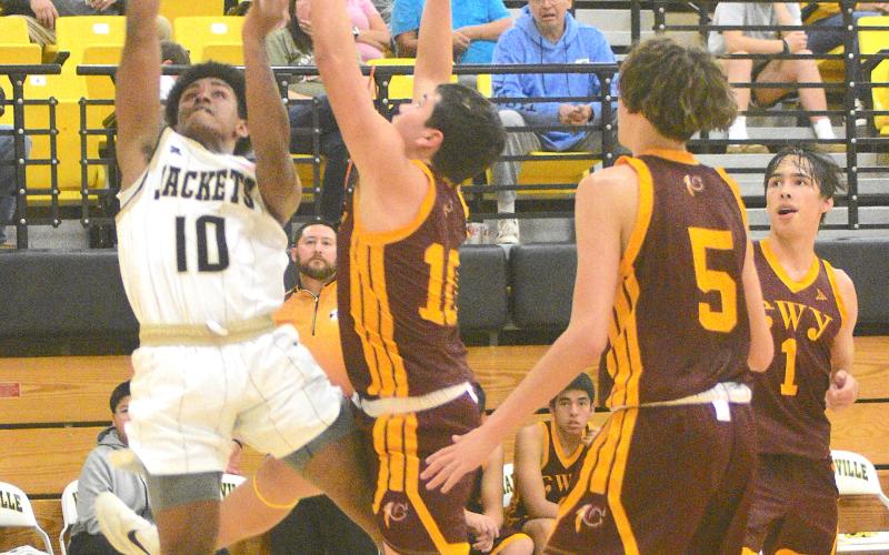 Gary Corsair • Clay County Progress Asher Brown, No. 10, slashes to the basket after zooming past three Cherokee Braves in Hayesville's victory last Tuesday.