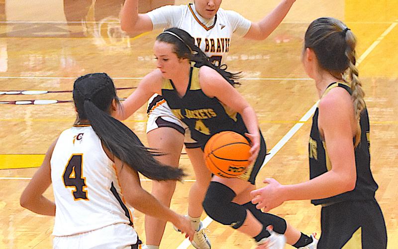 A pair of Cherokee defenders try to corral Hayesville dynamite Breanna Abrams, No. 4, as the Lady Jackets guard advances the ball past the time line as teammate Ava Shook looks on.