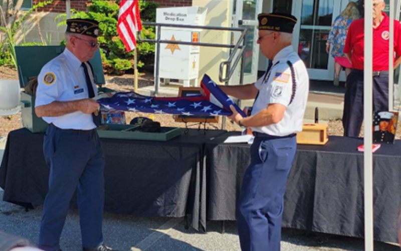 From left, Honor Guard Members Mitchell Shields and Phil Cantley fold the flag during a memorial ceremony at the Clay County Sheriff's Office.