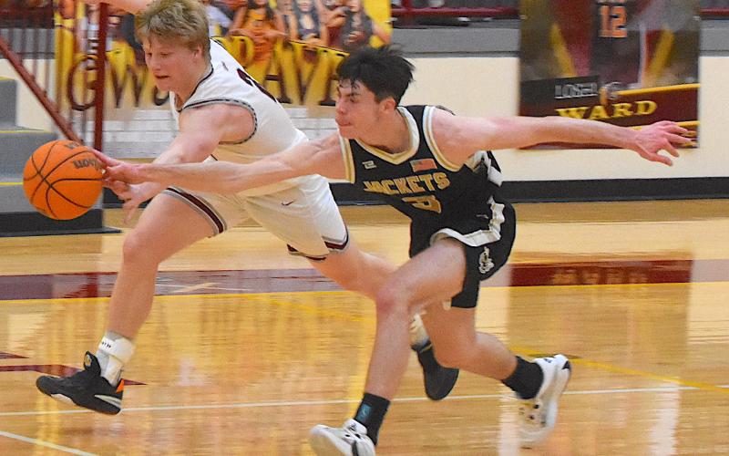 Gary Corsair• Clay County Progress Hayesville's Slade Crouch beats a Swain player to the ball in a race for possession near half court in the second half of the varsity Yellow Jackets victory.