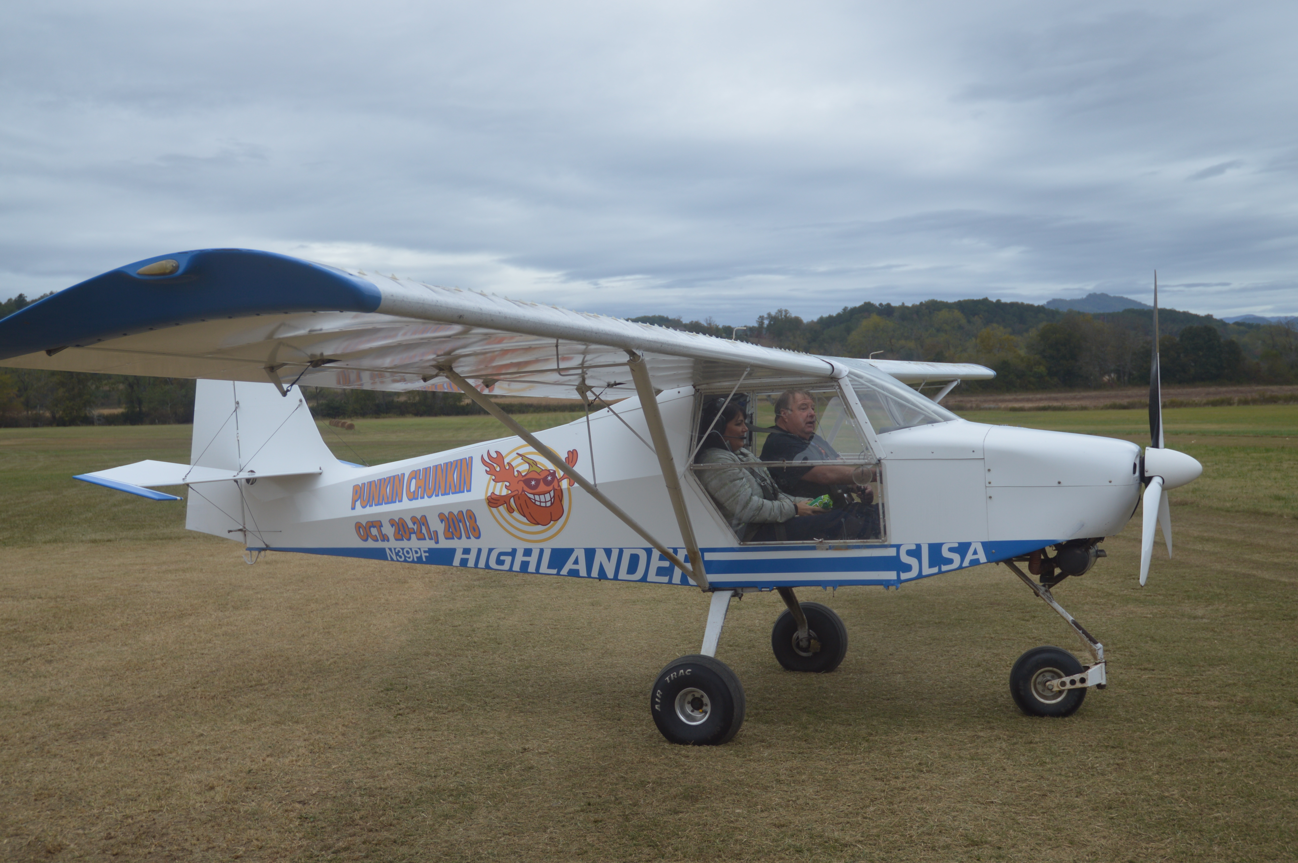 Pilot Vic Payne teaches a passenger the fine art of throwing T-shirts to the crowds. 