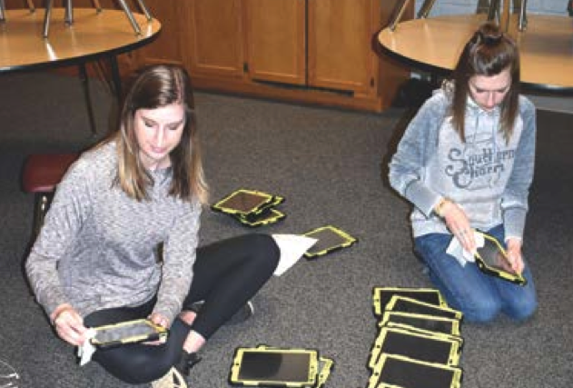 (Brittany Sullivan • Clay County Progress) Ensuring students safety, fifth grade team members Brittany Timpson and Adrianna Deaver spend Wednesday morning cleaning and sanitizing all devices.