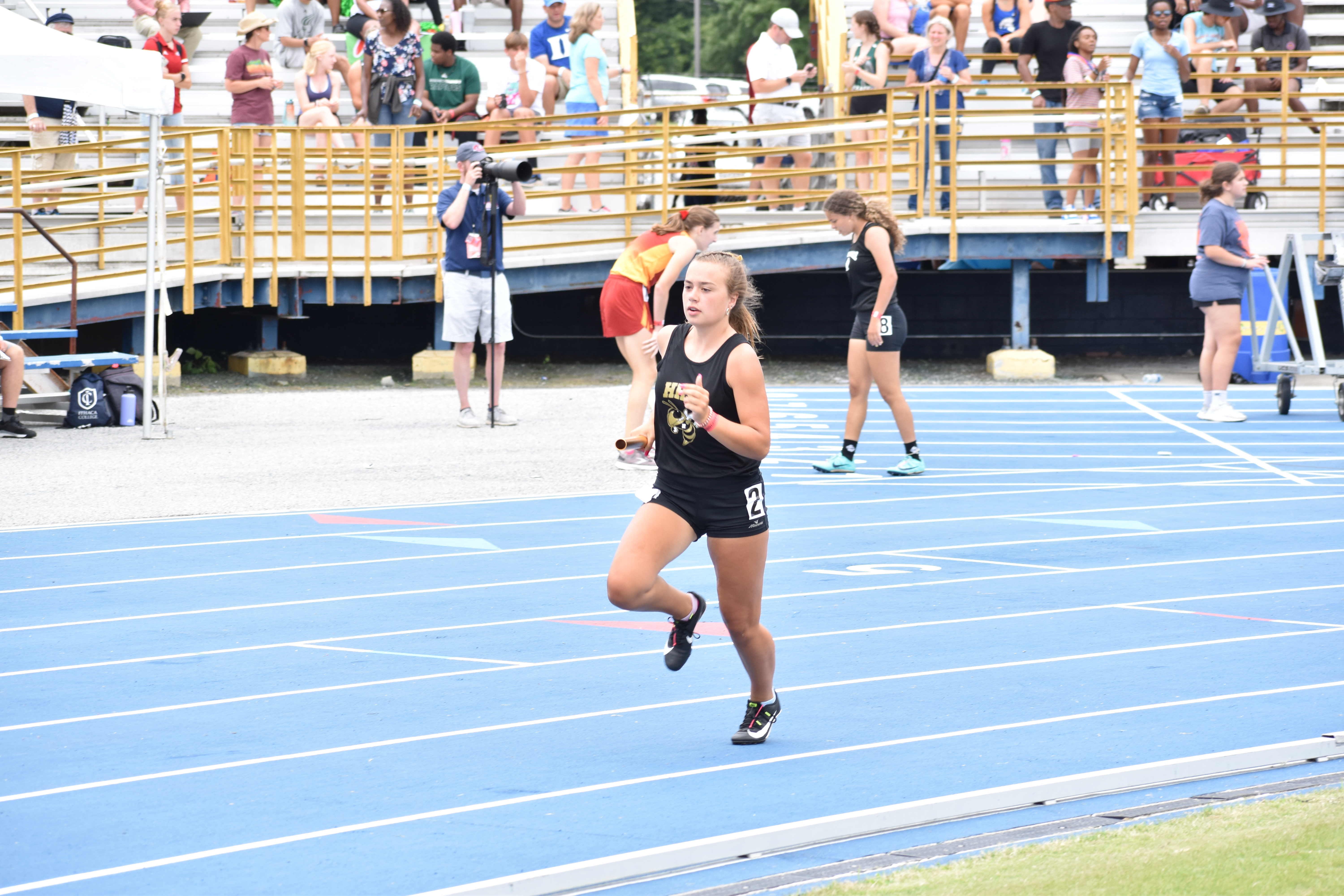 (Kevin Hensley • Graham Star) Lady Jacket Lila Roberts carries the baton for Hayesville in her leg of a relay.