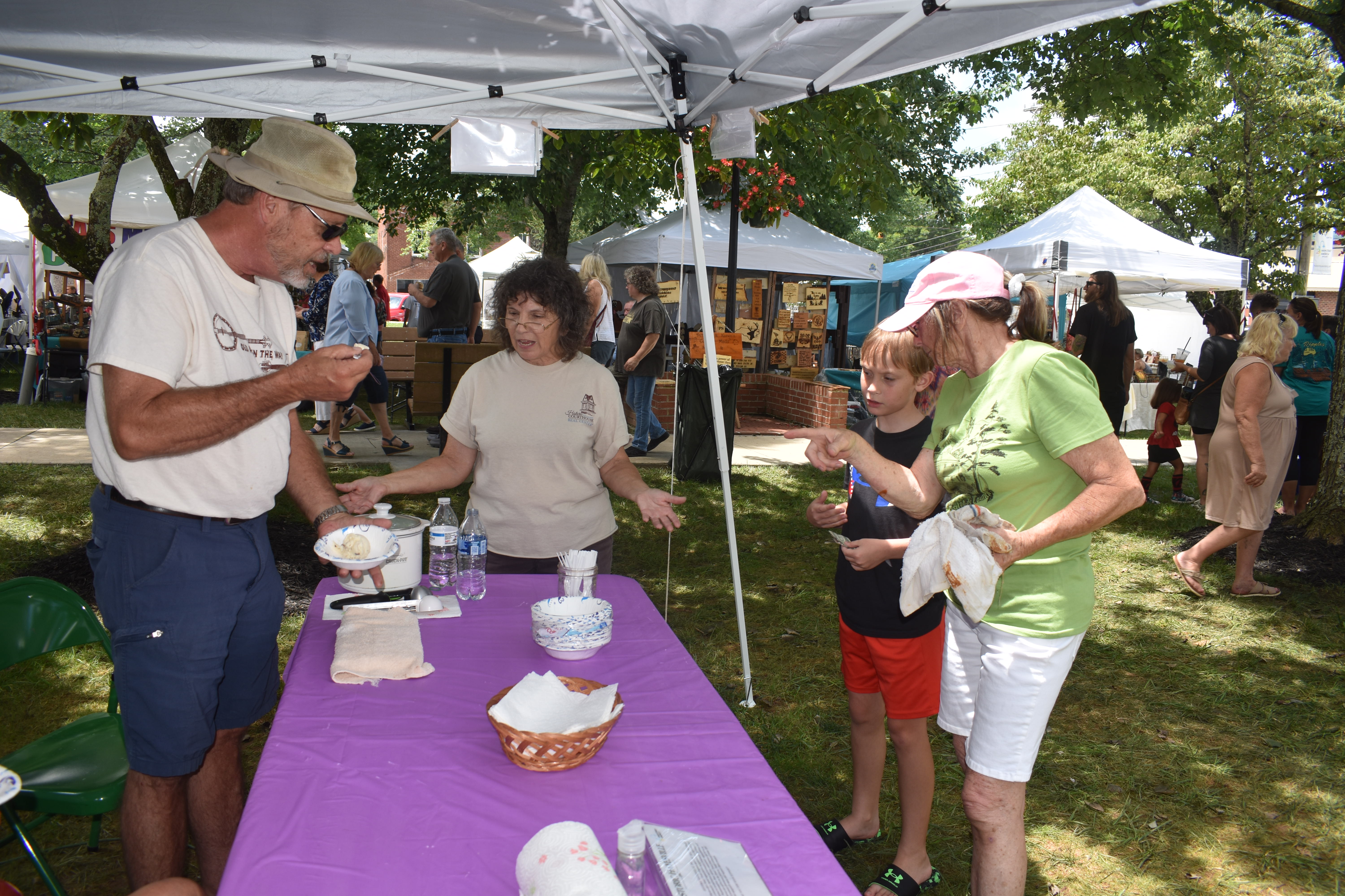 Pam Roman and grandson Jackson visit the ice cream booth.