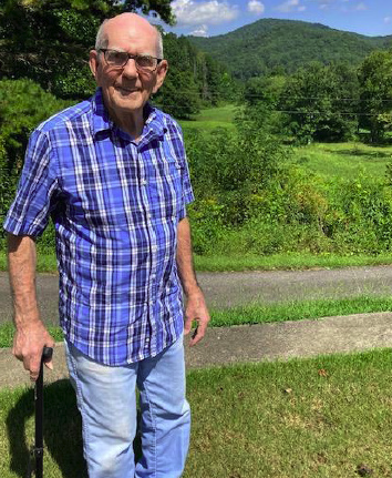 Herman Eller stands near the place where he was born on the face side of the mountain behind him in Titus, Towns County, Ga.