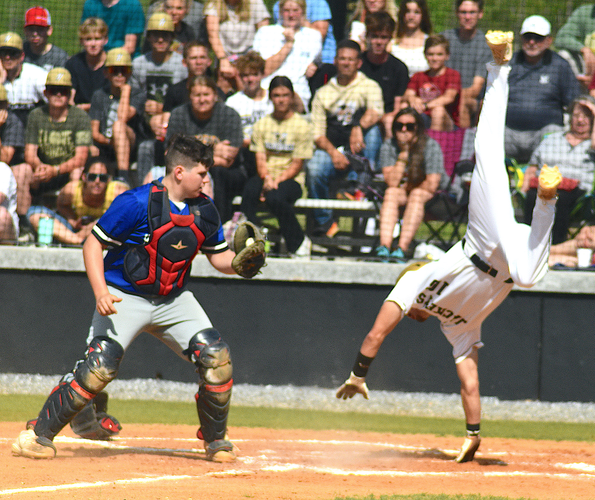 Gary Corsair • Clay County Progress Logan Caldwell tries to evade the tag by somersaulting home on a second-inning double steal against Hiwassee Dam.