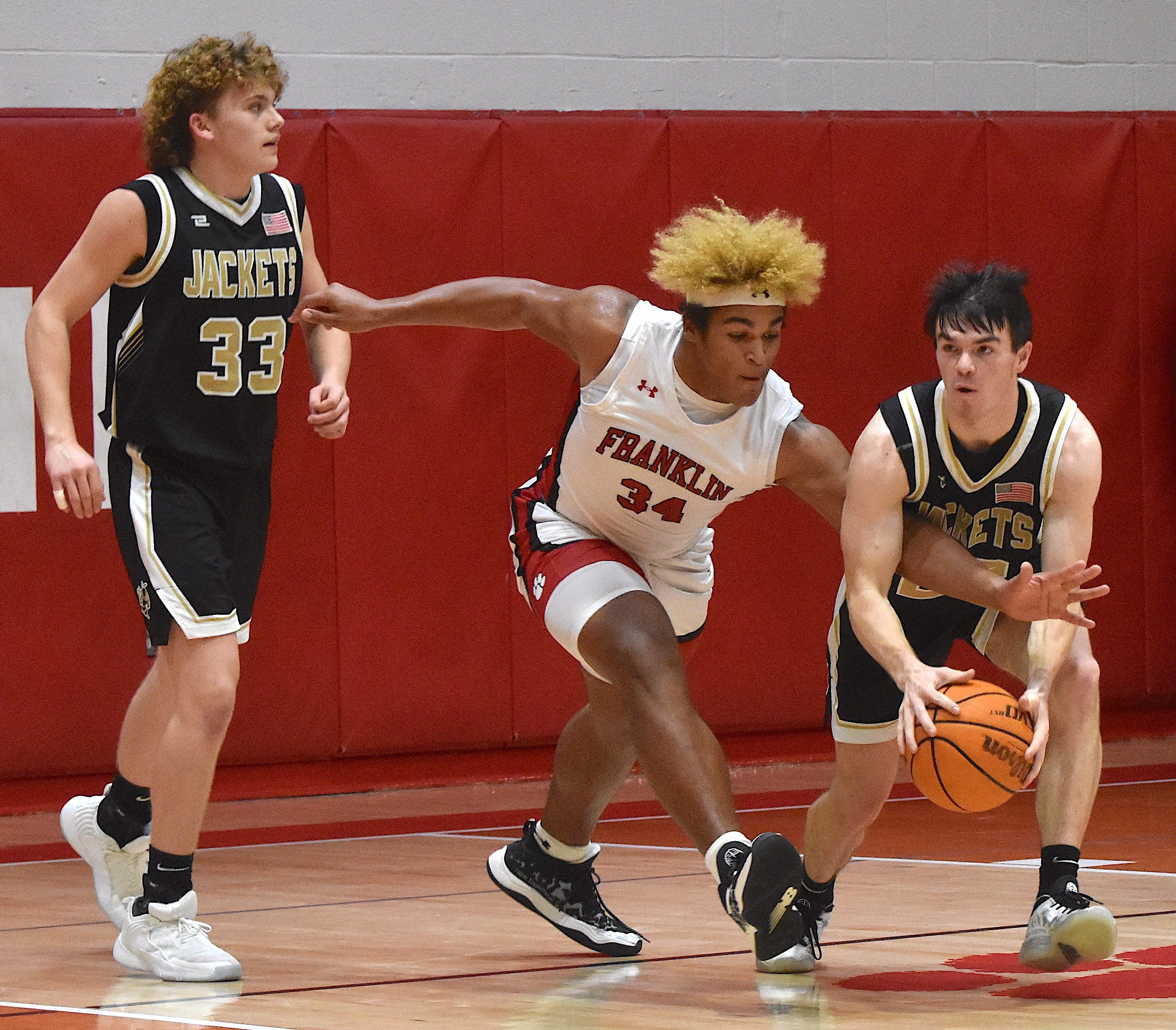 Gary Corsair • Clay County Progress Hayesville's Jacob McClure, No. 22, has a hairy experience as he starts the Hayesville fast break with Jackson Sellers, No. 33.