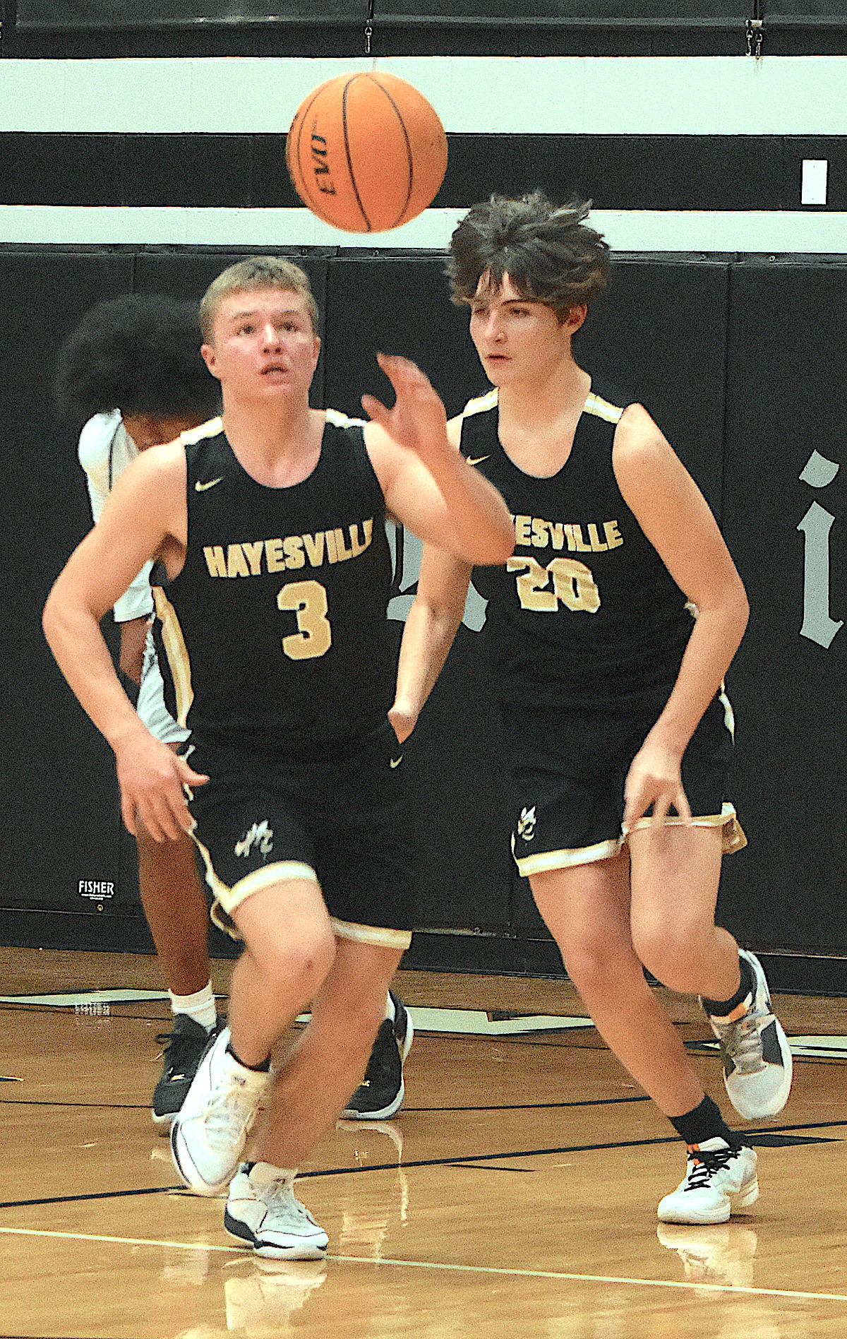 Gary Corsair • Clay County Progress E.J. Abrams, No. 3, and Damien Soto, No. 20, kick start the Hayesville fast break at Robbinsville.